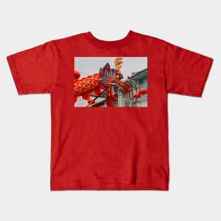 A closeup from the head of a long red dragon in profile Kids T-Shirt